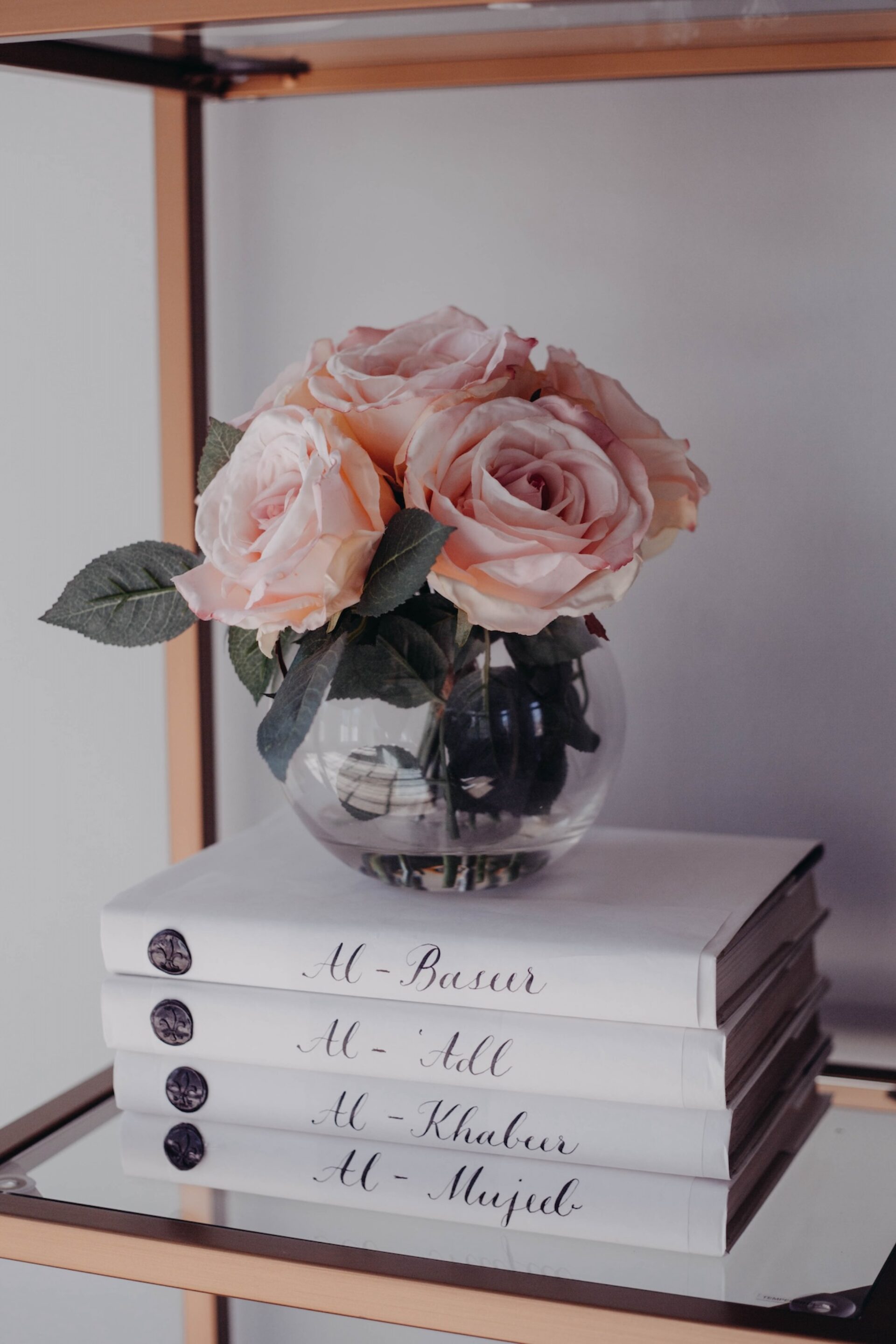Roses In Vase On Stacked Books