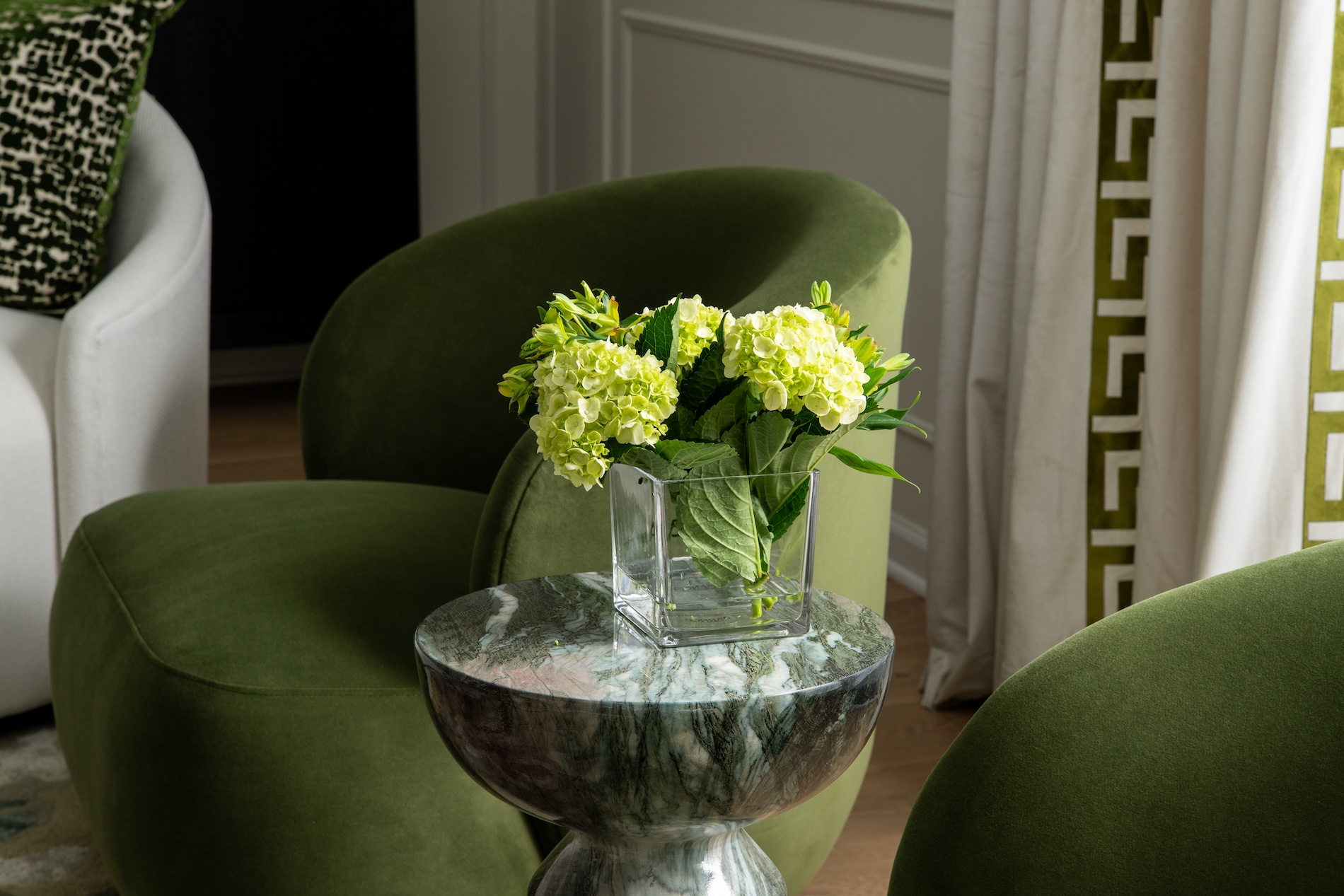 Round Marble Table Between Accent Chairs