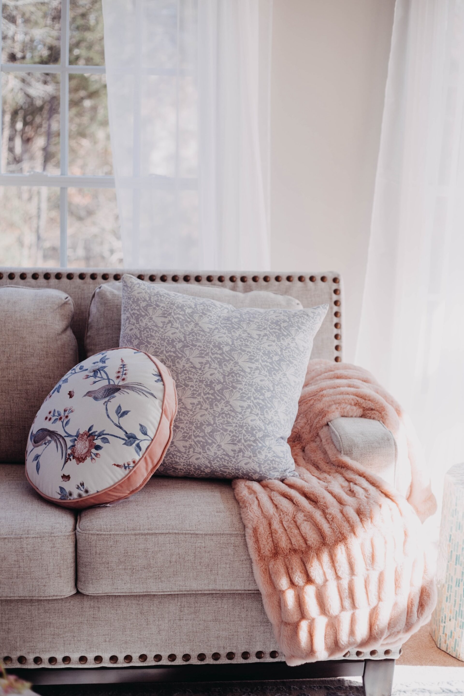 Sofa With Round Accent Pillow And Blanket